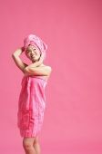 Woman wrapped in a pink towel, wearing pink turban, looking away - Asia Images Group