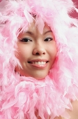 Woman with pink feathers around her face - Asia Images Group