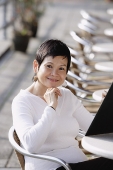 Mature woman in cafe, holding a menu - Asia Images Group
