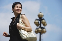 Mature woman carrying shoulder bag - Asia Images Group