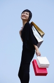 Woman carrying shopping bags - Asia Images Group