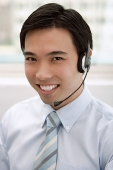 Businessman with headset on - Asia Images Group