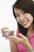 Woman holding Chinese tea cup - Asia Images Group
