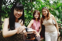 Women at outdoor garden cafe, looking at camera, portrait - Asia Images Group