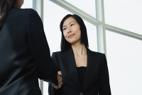 Businesswomen shaking hands - Asia Images Group