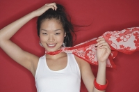 Woman in white top and scarf, looking at camera, hand on head - Asia Images Group