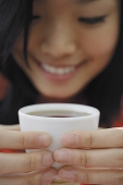 Woman holding teacup - Asia Images Group