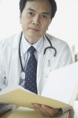 Doctor with folder, looking at camera - Asia Images Group