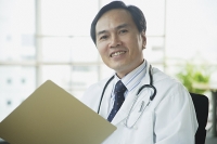Doctor smiling at camera - Asia Images Group
