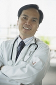 Doctor smiling at camera, arms crossed - Asia Images Group