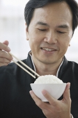 Man eating rice - Asia Images Group
