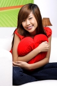 Young woman embracing pillow - Asia Images Group