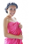 Young woman wearing shower cap and towel, smiling at camera - Asia Images Group
