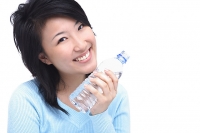 Young woman with bottle of water, smiling - Asia Images Group