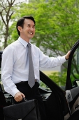 Businessman getting out of car - Asia Images Group