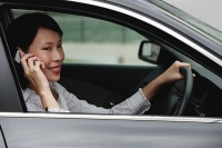 Businesswoman in car using mobile phone - Asia Images Group