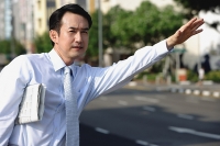 Businessman flagging a cab - Asia Images Group
