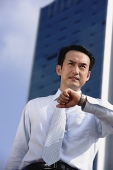 Businessman frowning, looking away - Asia Images Group
