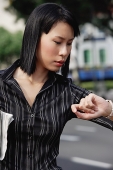 Businesswoman checking the time - Asia Images Group