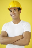 Man wearing hardhat, smiling at camera - Asia Images Group