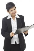 Businesswoman with folder, looking at camera - Asia Images Group
