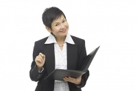 Businesswoman with folder and pen - Asia Images Group