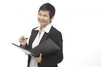 Businesswoman with folder and pen, looking away - Asia Images Group