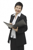 Businesswoman with folder and pen, portrait - Asia Images Group
