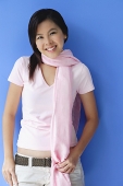Young woman wearing scarf around her neck, smiling at camera - Asia Images Group