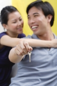 Couple embracing, man holding keys, - Asia Images Group