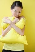 Woman embracing pillow - Asia Images Group