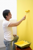 Man painting wall - Asia Images Group