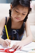 Young girl drawing with coloured pencils - Asia Images Group