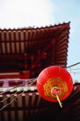 Red lantern hanging from wire - Asia Images Group