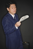 Businessman reading newspaper - Asia Images Group