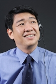 Businessman using hands free device - Asia Images Group