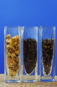 Row of three glass containers with tea leaves - Asia Images Group