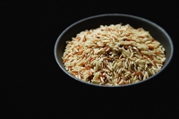 Still life of Bowl of rice against black background - Asia Images Group