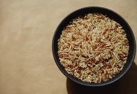 Bowl with uncooked rice - Asia Images Group