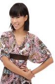 Young woman with hand on hip, smiling at camera - Asia Images Group