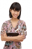 Young woman with arms crossed, smiling at camera - Asia Images Group