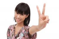 Young woman smiling at camera, making peace sign - Asia Images Group