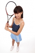Young woman with tennis racket, looking up at camera - Asia Images Group