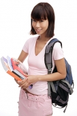 Young woman carrying backpack and books - Asia Images Group