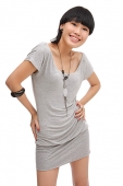 Young woman smiling at camera, hands on hips - Asia Images Group
