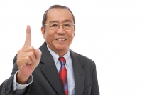 Businessman looking at camera, raising finger - Asia Images Group