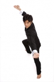 Young man practicing martial arts, looking at camera - Asia Images Group