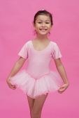 Young girl in ballerina costume, smiling at camera - Asia Images Group