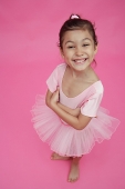 Young girl in ballet outfit, arms crossed, smiling - Asia Images Group