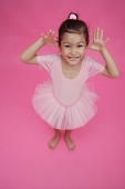 Young girl in ballet outfit, hands on either side of face - Asia Images Group